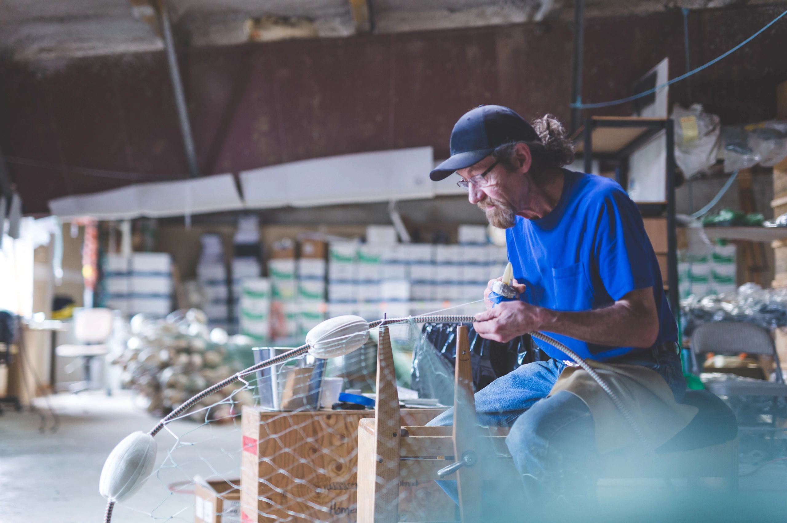 Fisherman working carefully on equipment in a workshop