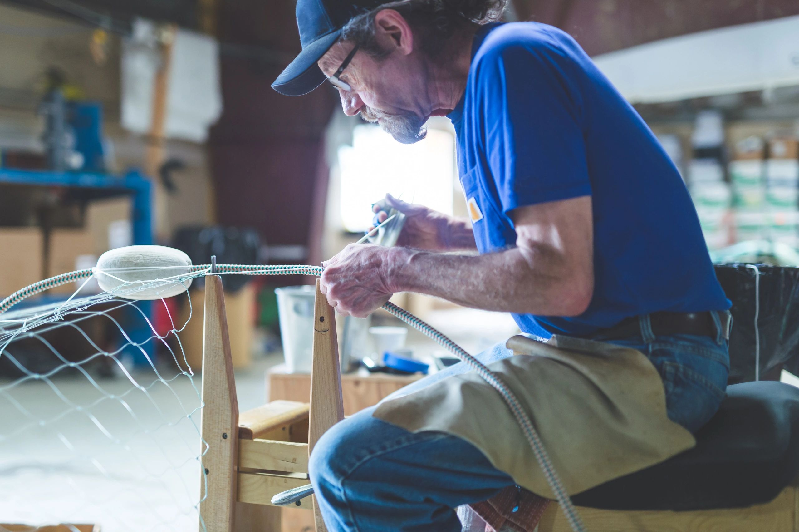 Fisherman preparing gear in a workspace
